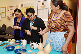 Three women looking at traditional food. Three women looking at traditional food.